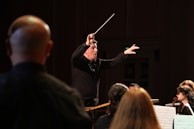 An engaging workshop with a conductor guiding young singers in vocal techniques.