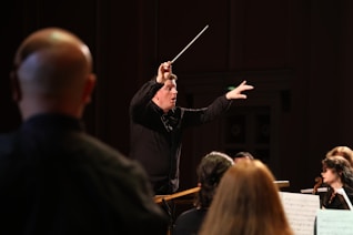 A conductor guiding a choir with expressive hand movements