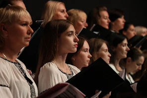 A joyful group of gospel students rehearsing under the guidance of their choir leader.