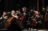 A group of young musicians playing violin and cello at a charity concert.
