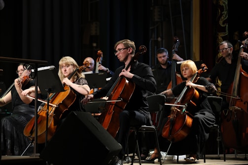 A group of young musicians playing violin and cello at a charity concert.