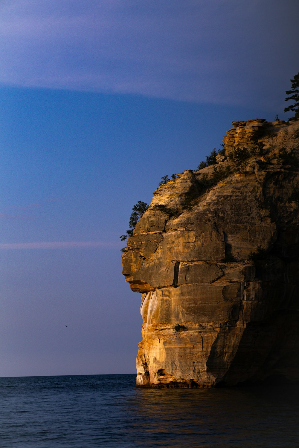 a large rock outcropping in the middle of the ocean