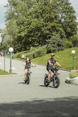 A happy rider on an e-bike cruising along a tree-lined path in Central Park.