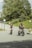 A group of employees happily riding electric bikes in a city park.