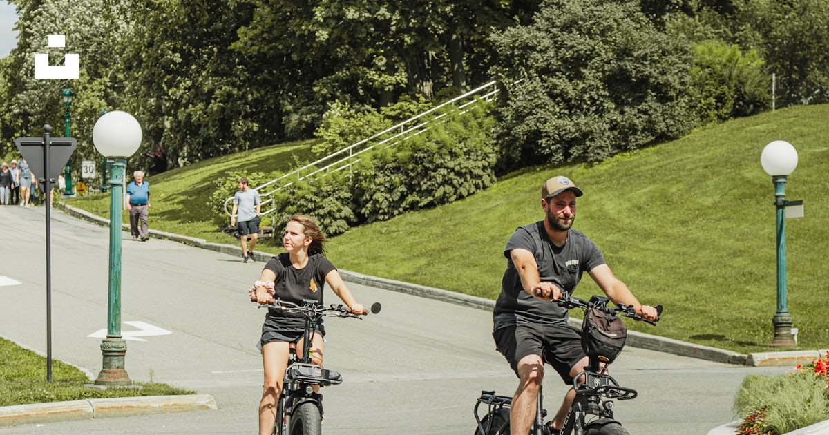 A couple of people riding on the back of motorcycles photo – Free ...