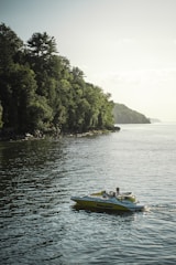 A family enjoying a day on a spacious pontoon boat with clear skies and calm waters.