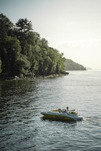 A family enjoying a day on a spacious pontoon boat with clear skies and calm waters.