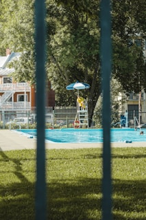 A vigilant lifeguard attentively watching over a swimming pool, ready to assist.