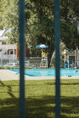 A vigilant lifeguard attentively watching over a swimming pool, ready to assist.