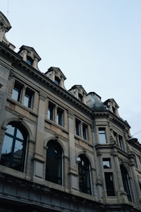 Renovated historic building exterior with modern architectural details under clear sky.