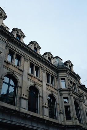 Renovated historic building exterior with modern architectural details under clear sky.