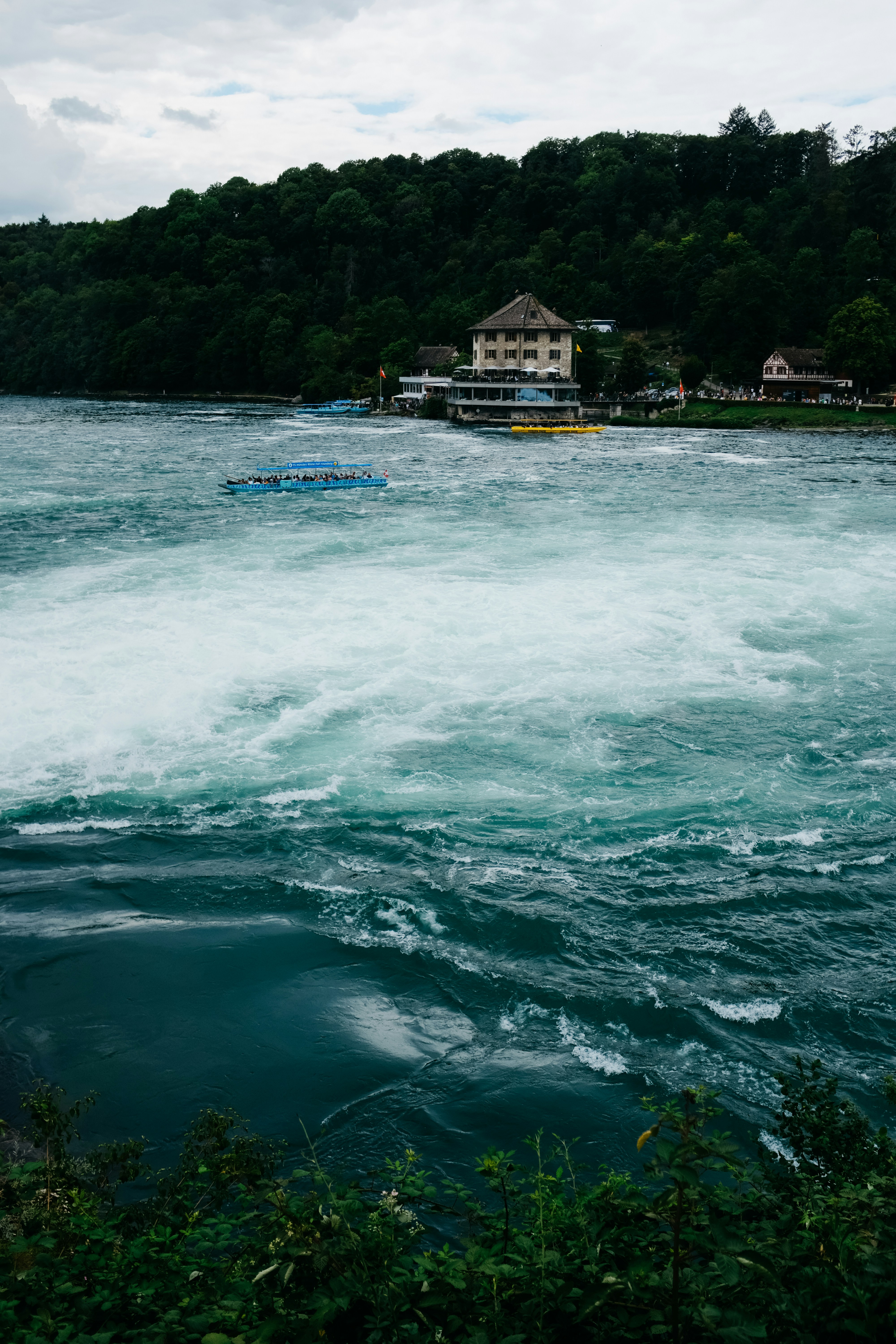 a body of water with a house in the background