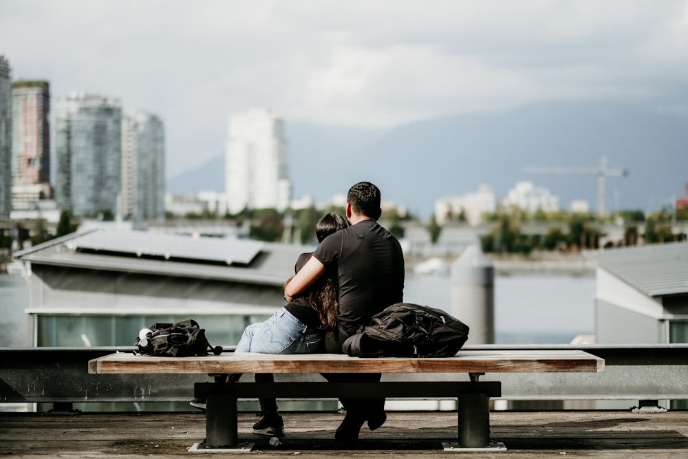 a man and a woman sitting on a bench