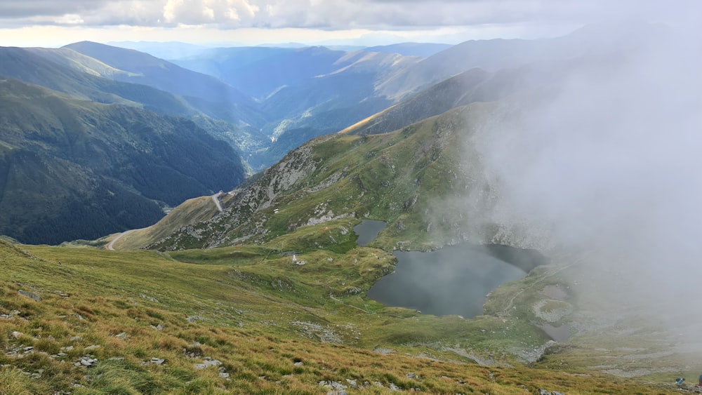 a view of a valley with a lake in the middle of it