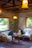 A warm, inviting living room inside a private apartment at Hostal Aztec with terracotta and emerald green accents.