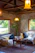 A warm, inviting living room inside a private apartment at Hostal Aztec with terracotta and emerald green accents.