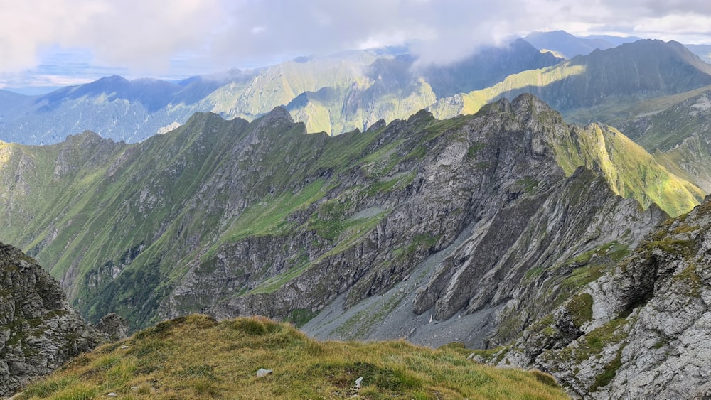 a view of a mountain range from the top of a hill