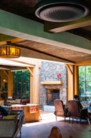 A cozy living room with warm natural light, wooden beams, and a fireplace inviting family gatherings.