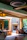 Family relaxing by the fireplace inside a warmly lit guest house room with rustic decor.