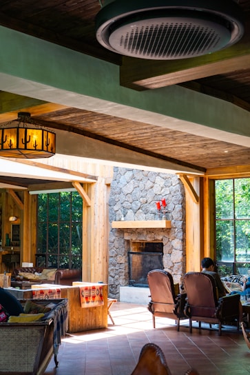 Cozy living room with exposed wooden beams and warm lighting in a historic half-timbered apartment.