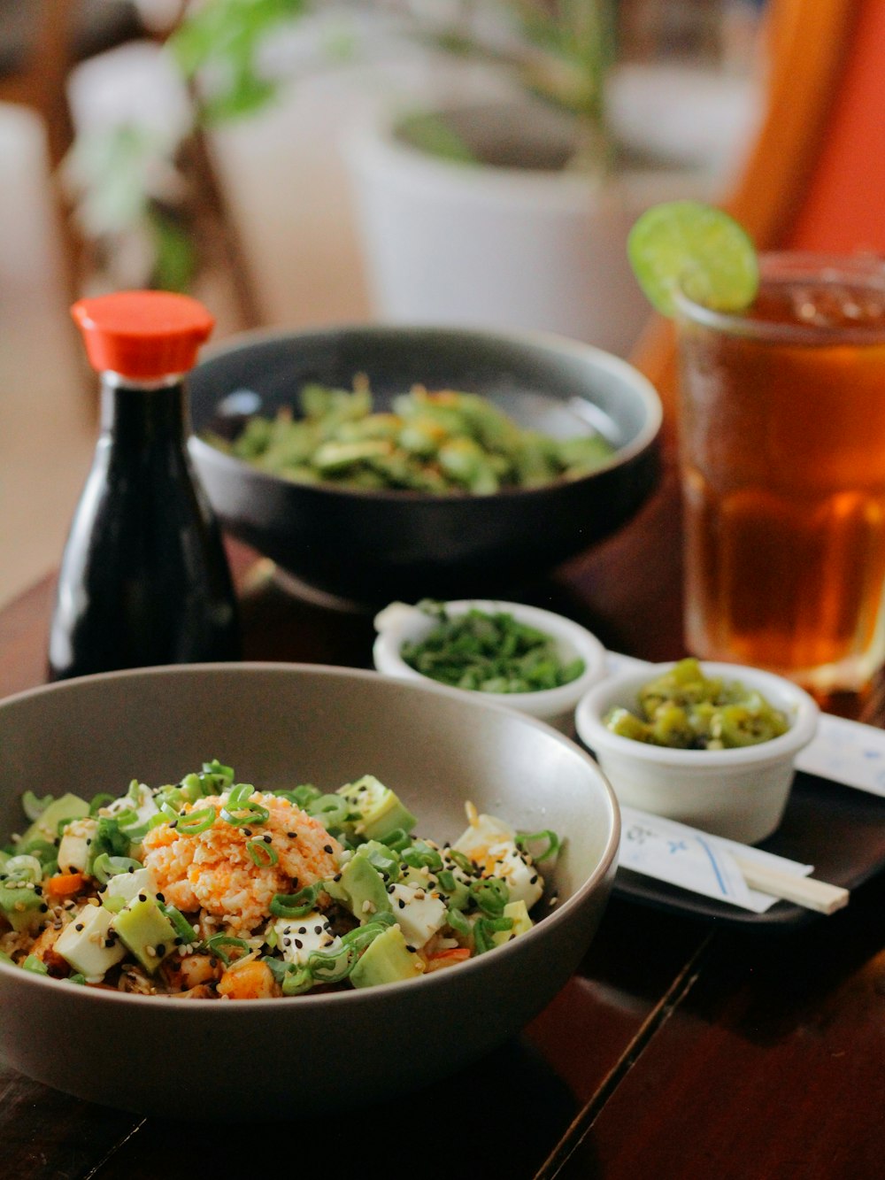 a wooden table topped with bowls of food