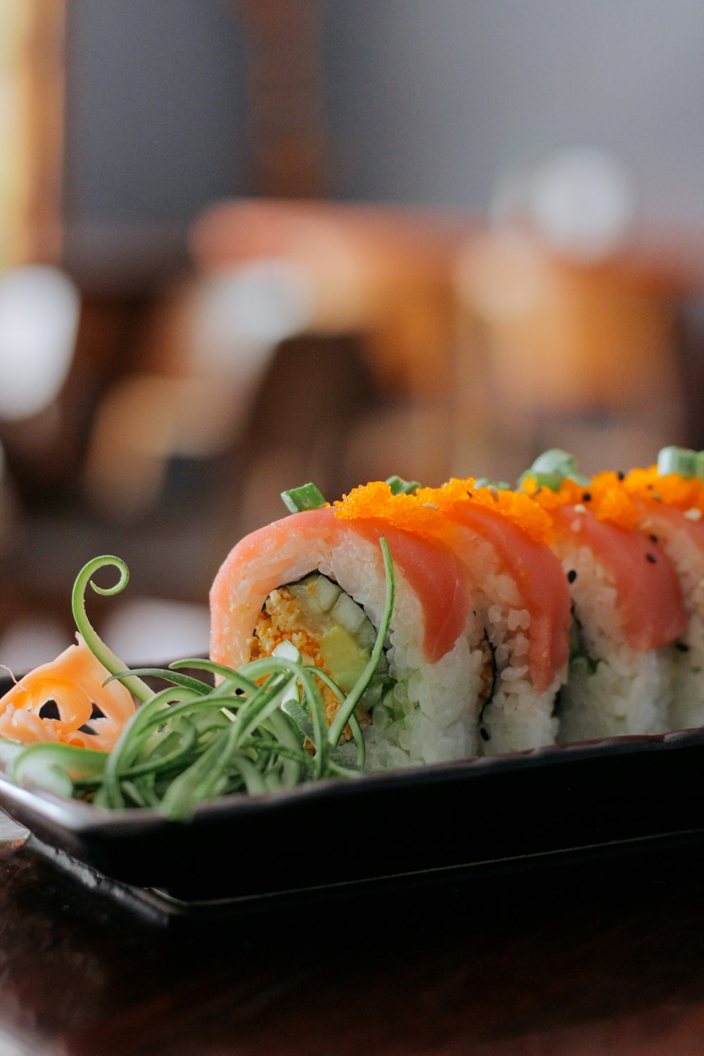 a plate of sushi on a wooden table