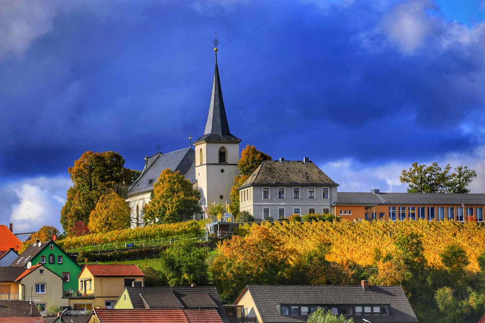 a small town with a church on top of a hill