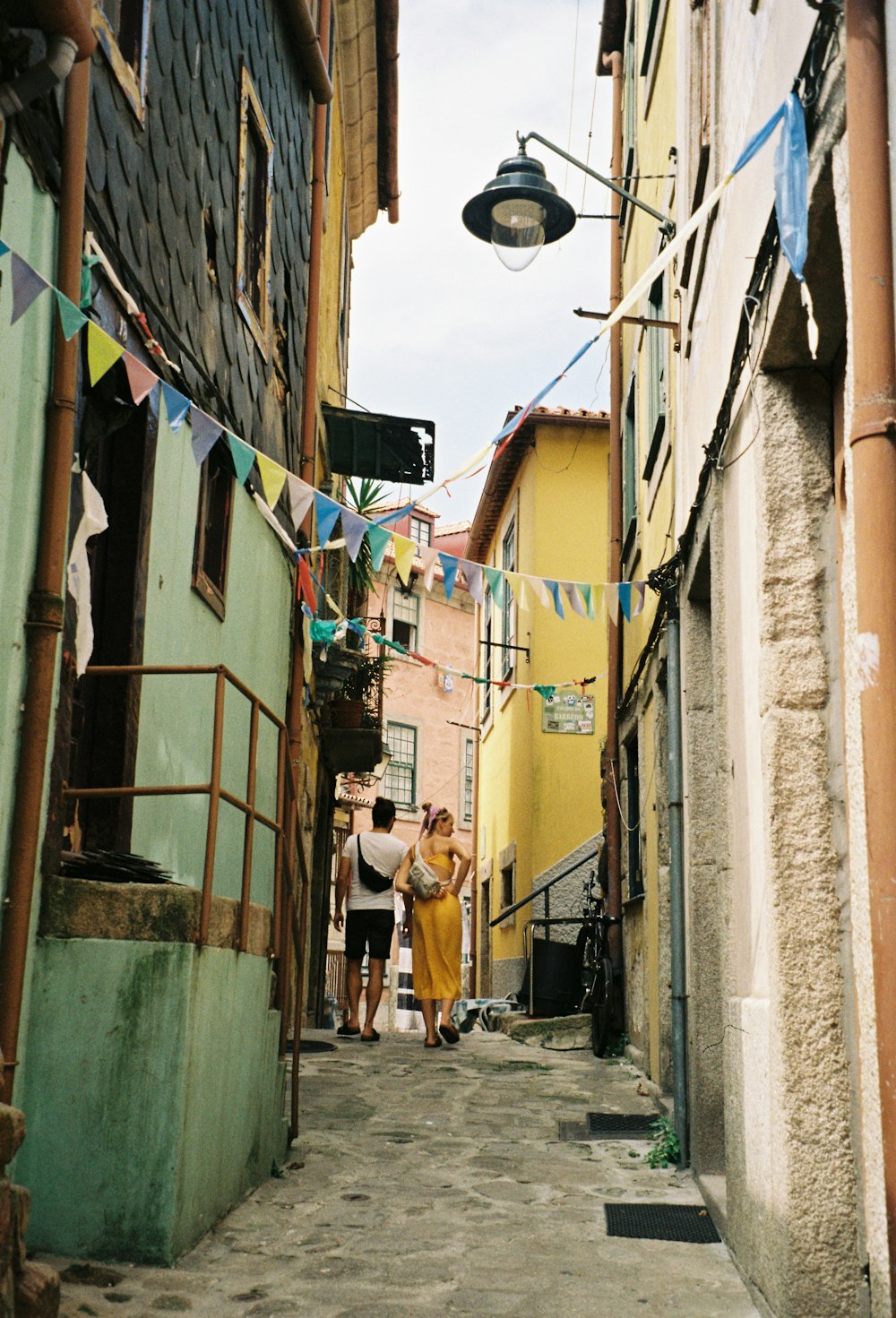 a couple of people that are walking down a street