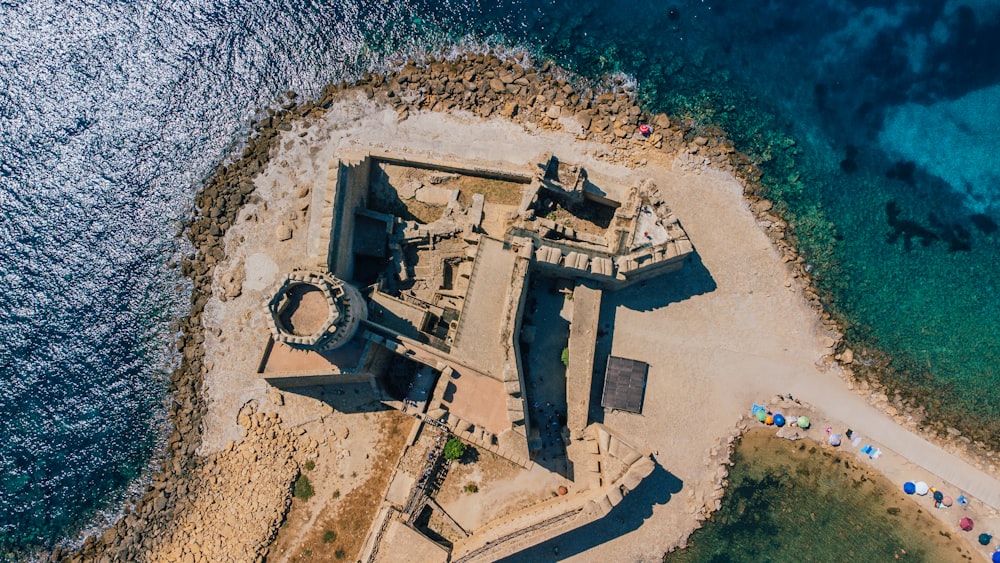 an aerial view of a castle in the ocean