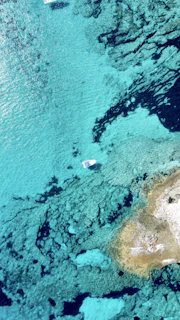 A scenic view of a turquoise sea with a small boat ready for excursions.