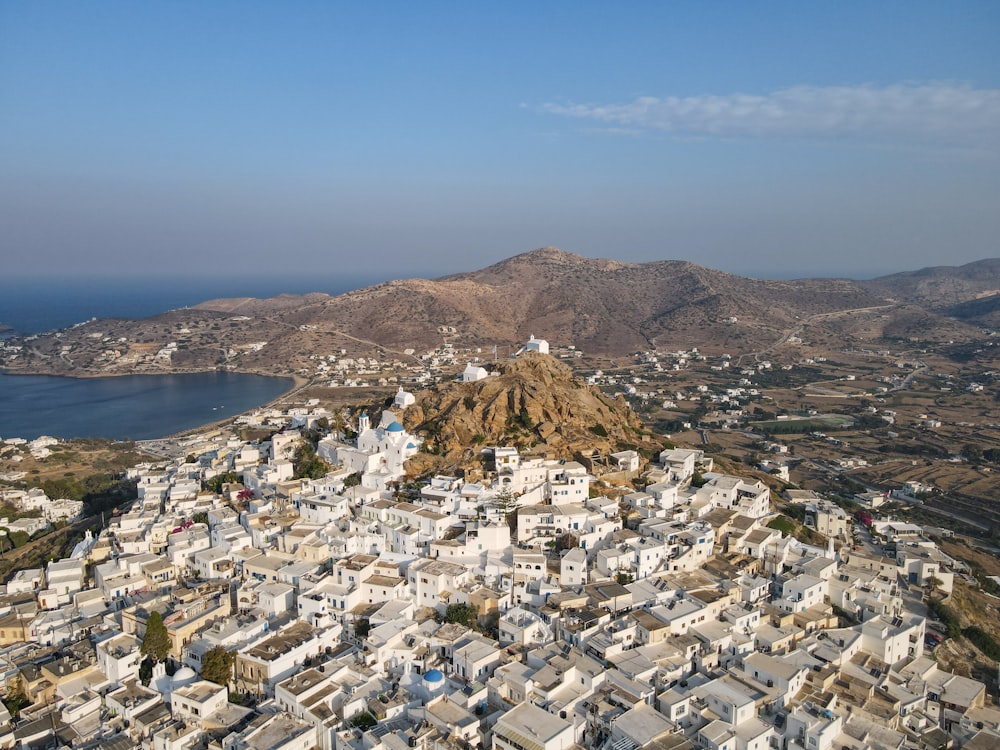 an aerial view of a city with mountains in the background