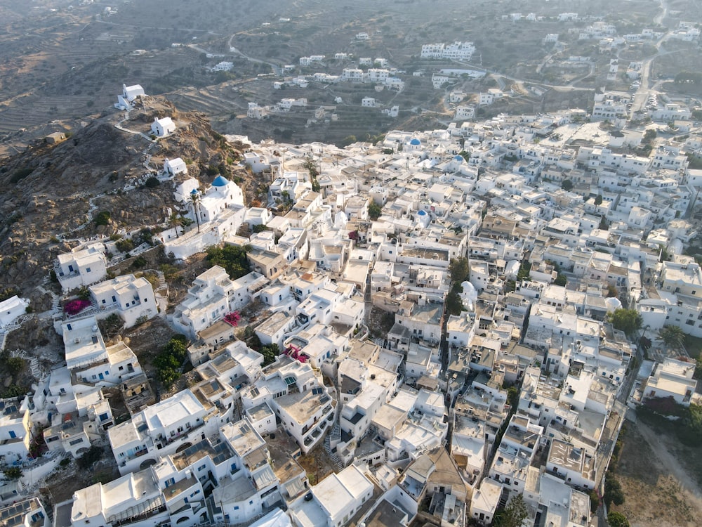 an aerial view of a city with lots of white buildings