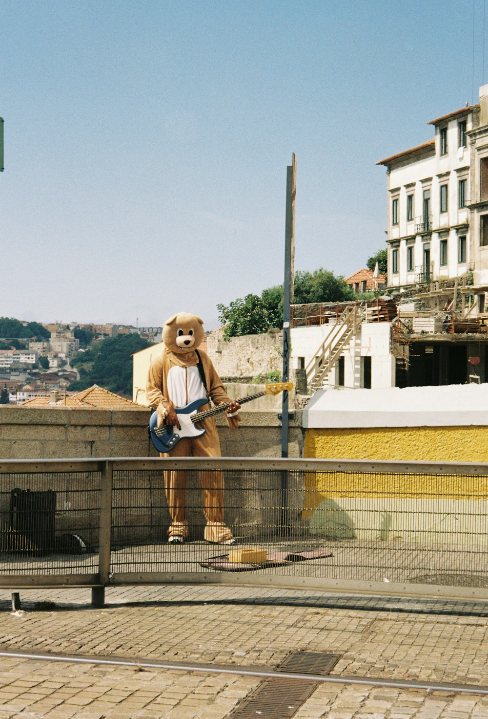 a man in a bear costume is playing a guitar