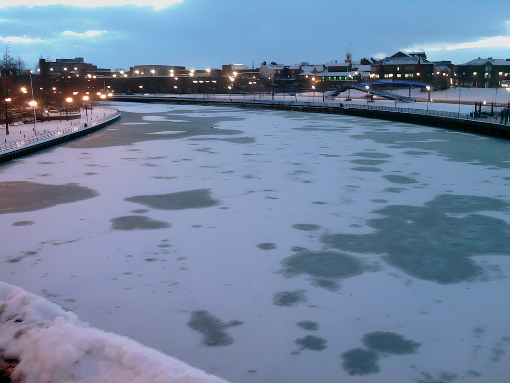 a large body of water surrounded by snow