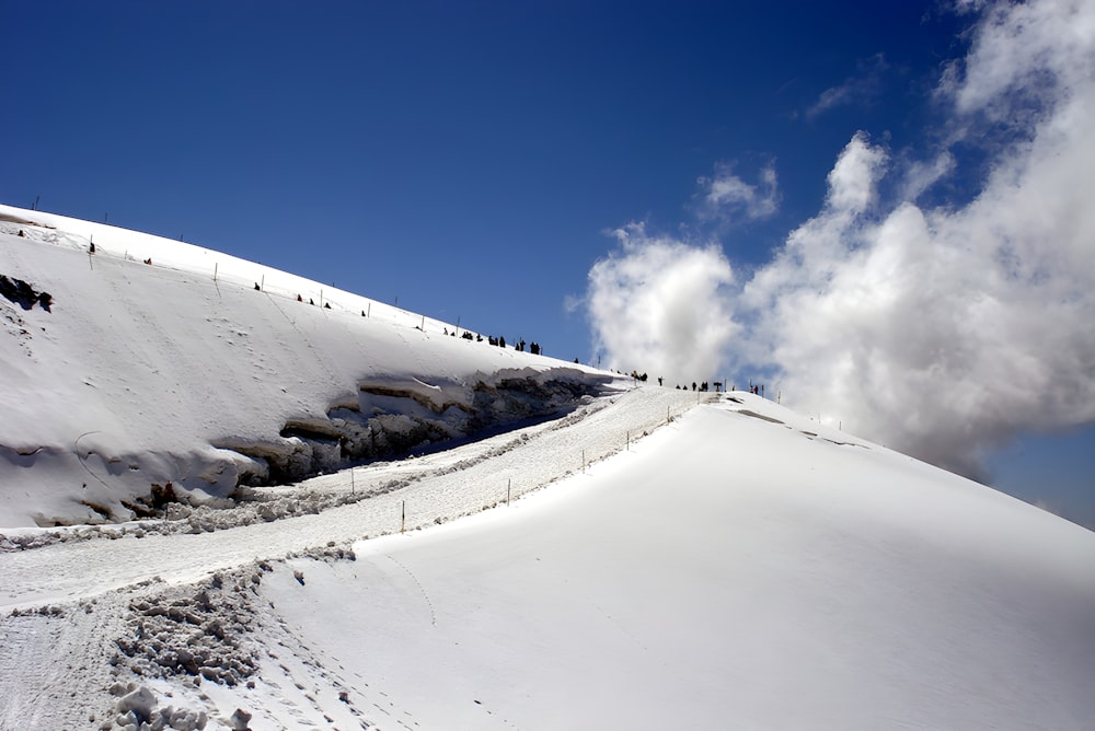 a group of people standing on top of a snow covered slope