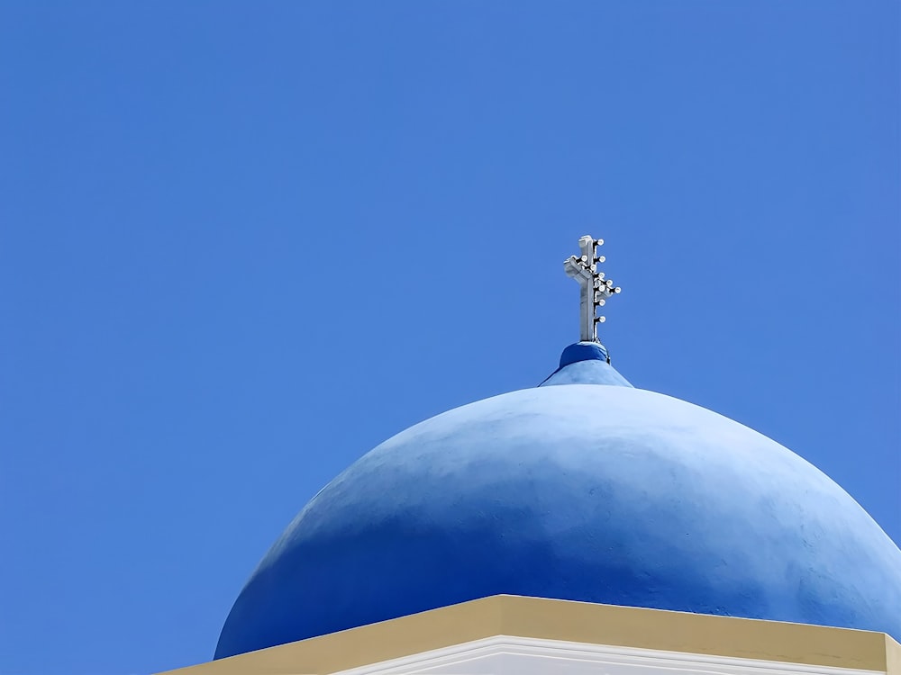 a blue dome with a cross on top of it