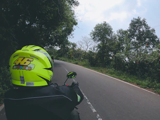 Rider wearing a helmet on a Yamaha bike cruising along a river road in Guaviare