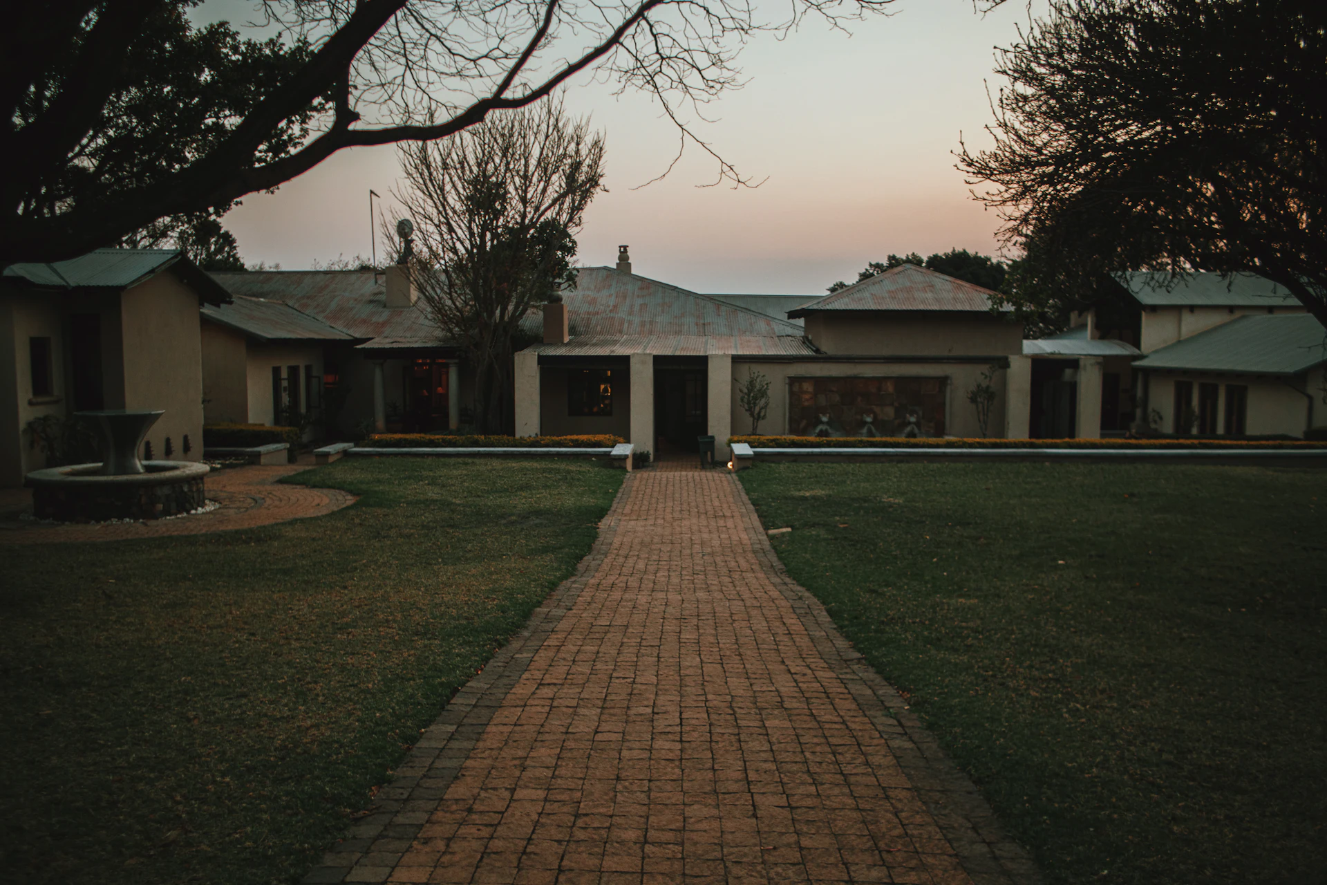 Brick path through the garden to the lodge at dusk
