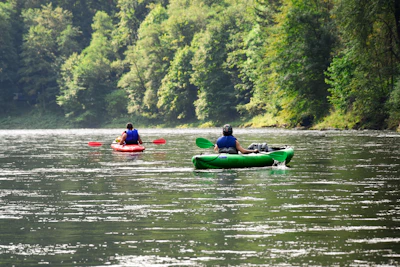 Couple enjoying a peaceful kayak ride surrounded by lush greenery in Xochimilco.
