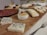 A vibrant display of assorted cold cuts and cheeses on a wooden platter.