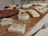 A vibrant display of assorted cold cuts and cheeses on a wooden platter.