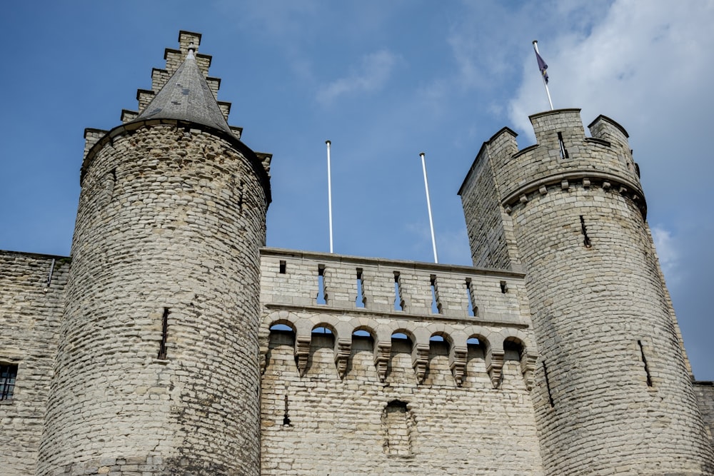 a castle with two towers and flags on top of it
