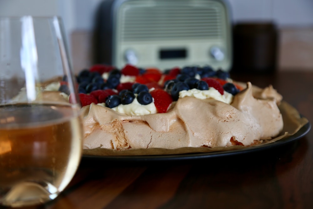 a plate of food and a glass of wine on a table