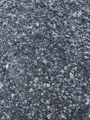 Close-up of rich, earthy pea gravel piles ready for delivery.