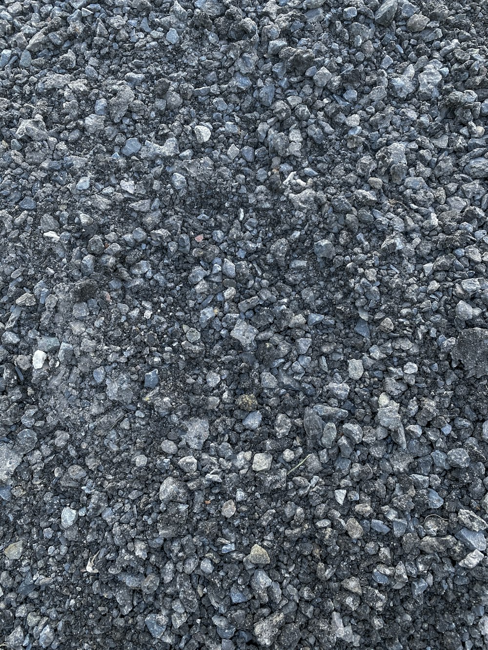 a close up of a street with rocks and gravel