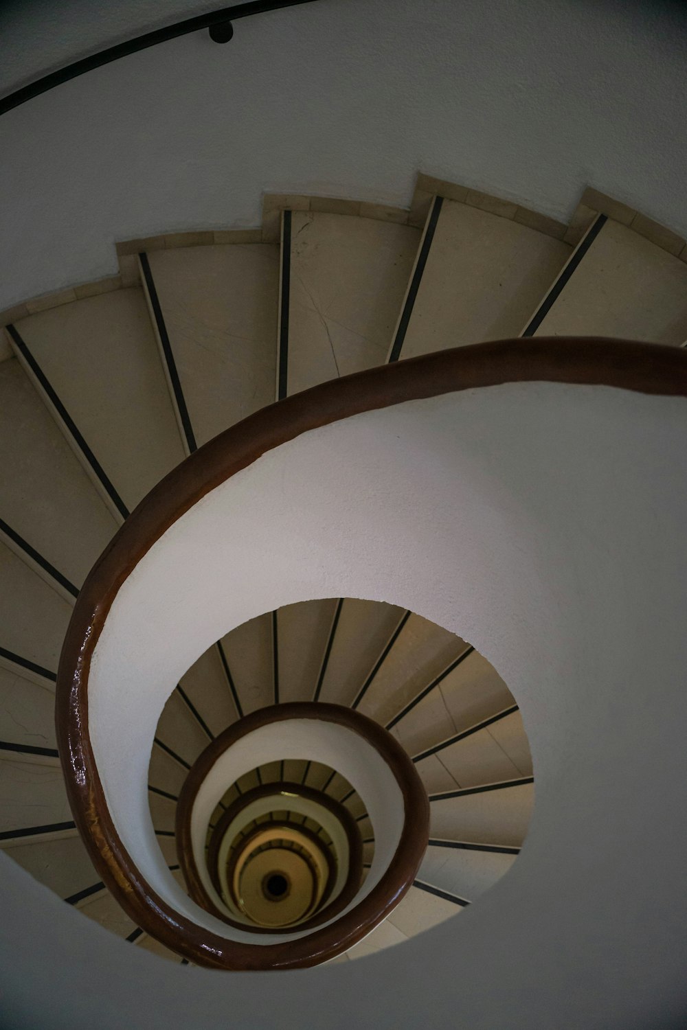 a spiral staircase in a building with white walls