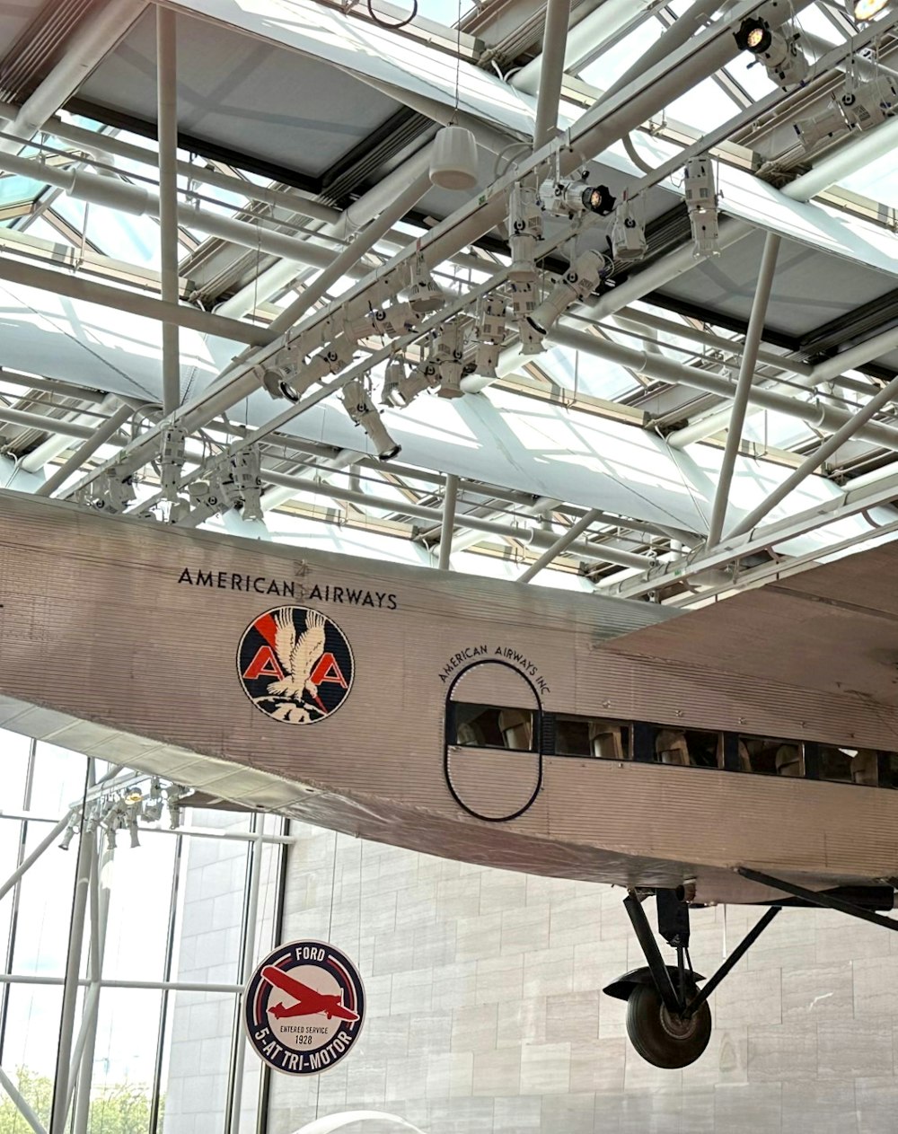 an airplane hanging from the ceiling of a building