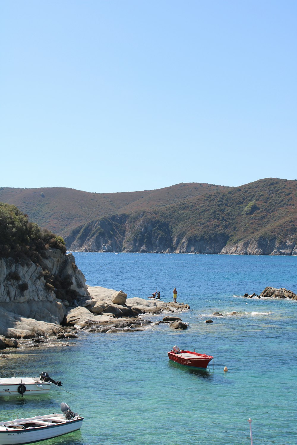 a group of boats floating on top of a body of water