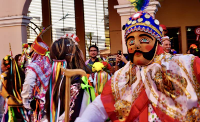 A vibrant community festival celebrating cultural traditions with colorful costumes and joyful faces.
