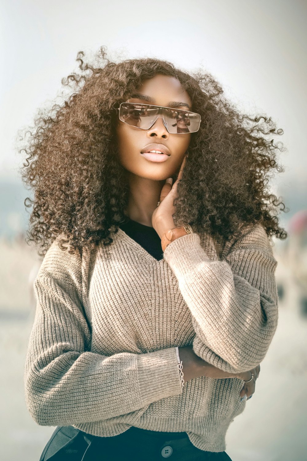 a woman wearing glasses and a sweater